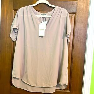 Cute tan colored blouse. Short sleeved v-neck